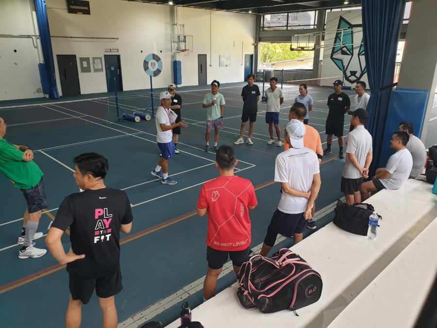 Players lined up on court at a group pickleball session