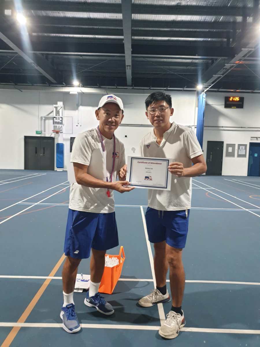 Coach Gary Tan presenting a PPR coaching certificate to a newly certified pickleball coach in Singapore